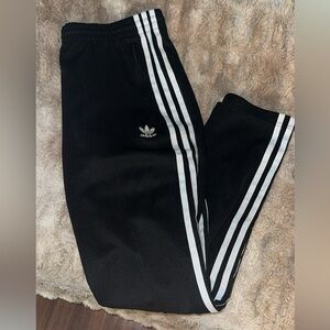 Size medium black Adidas Track pants with zippers on pockets and ankles